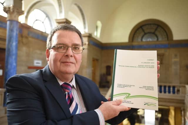Cllr David Seaton with a past copy of the budget