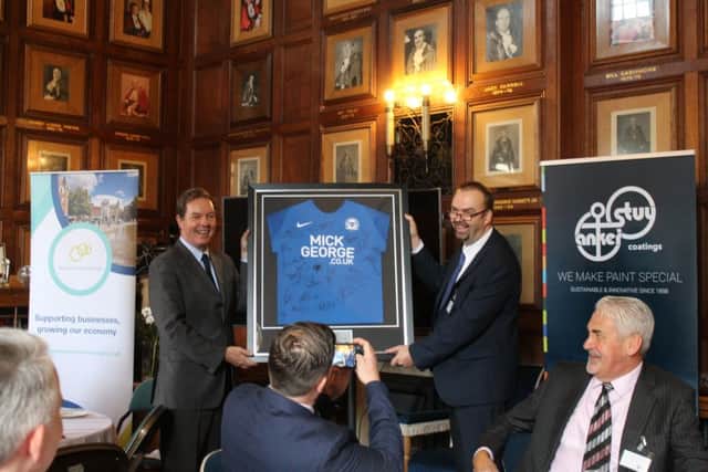 The Duch Ambassador Simon Smits, left, receives a signed Peterborough United shirt from Simon Coward, Opportunity Peterboroughs Head of Economic Development.