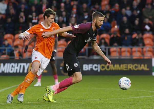 Mark Beevers of Peterborough United in action with Matty Virtue of Blackpool. Photo: Joe Dent/theposh.com.