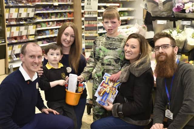Tesco, Werrington staffMark Rafferty, Nick Panniall and Nina McLaren and son Luca McLean (5)  handing over gifts to Louise Stimpson and her son Isaac Simpson (9). EMN-190111-180350009