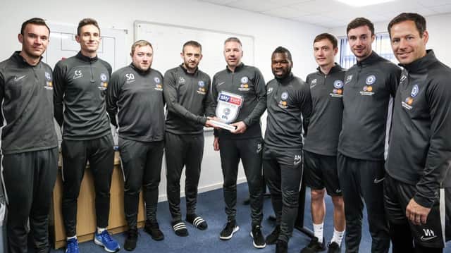 Darren Ferguson with his League One manager-of-the-month award and his Posh management staff. Photo: Joe Dent/theposh.com.