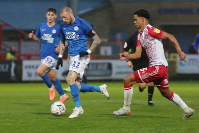 Marcus Maddison of Peterborough United in action with Terence Vancooten of Stevenage. Photo: Joe Dent/theposh.com.