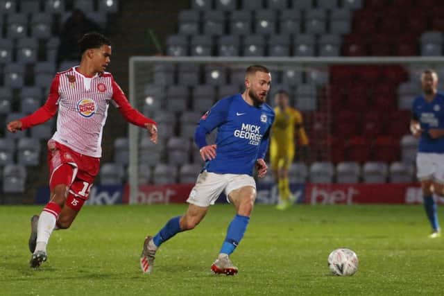 Dan Butler of Peterborough United in action with Terence Vancooten of Stevenage. Photo: Joe Dent/theposh.com.