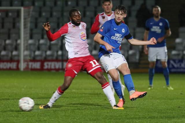 Harrison Burrows of Peterborough United in action with Emmanuel Sonupe of Stevenage. Photo: Joe Dent/theposh.com.