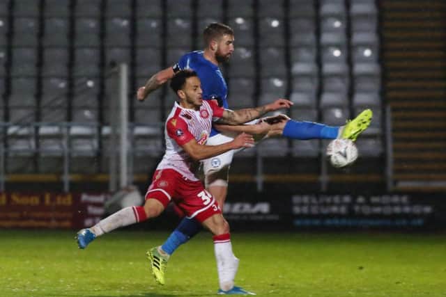 Mark Beevers of Peterborough United in action with Elliott List of Stevenage. Photo: Joe Dent/theposh.com