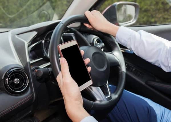 Police are clamping down on motorists using a phone while behind the wheel