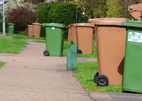 Brown and green recycling bins being collected in Werrington, Peterborough.