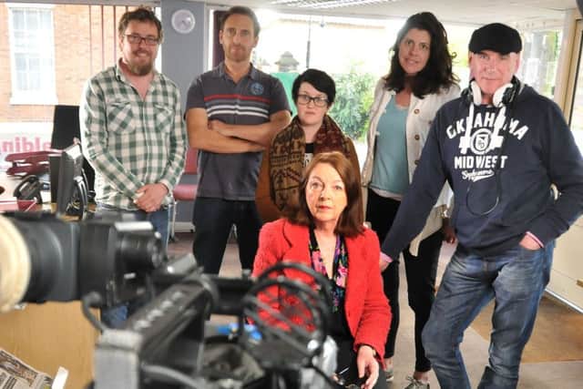 Reporter Lynne Harrison (seated) with members of the crew filming for CBS Reality. SG280415-112TW