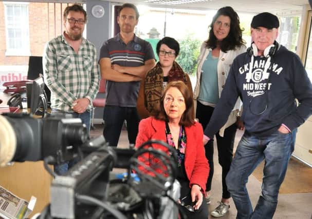 Reporter Lynne Harrison (seated) with members of the crew filming for CBS Reality. SG280415-112TW