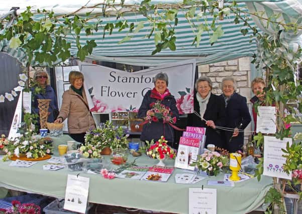 Members of Stamford Flower Club hold a stall on Stamford market on National Flower Arranging Day. EMN-150805-174916001