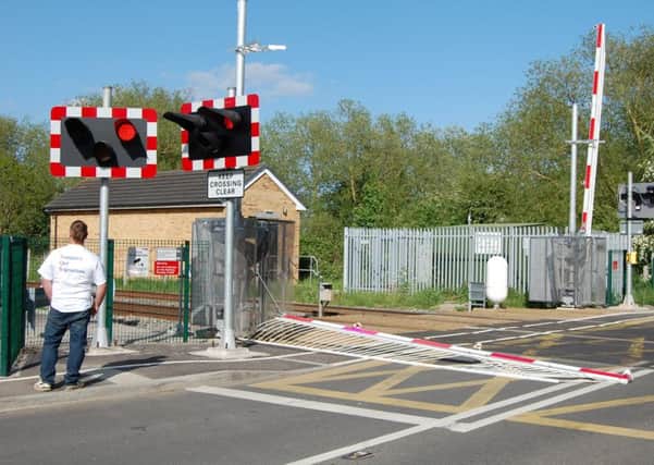 A barrier at the level crossing in Station Road, Deeping St James, was damaged after a vehicle drove into it on May 16, 2015. Photo: Stuart Hall. EMN-150518-103702001