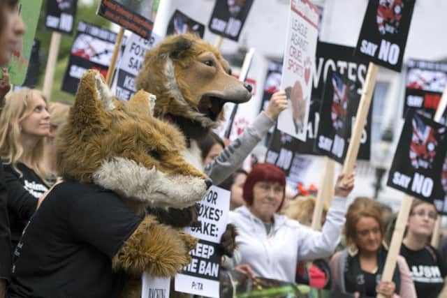 Anti-foxhunting protesters gather outside the Houses of Parliament, London. Photo: Anthony Devlin/PA Wire ENVIRONMENT_Foxhunting_120563.JP