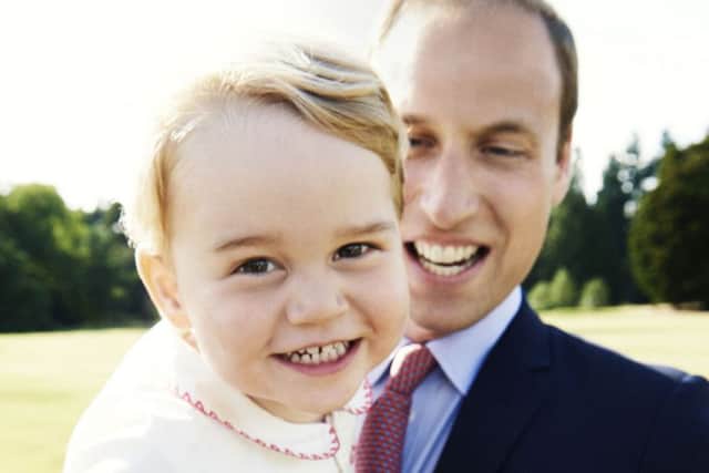 Prince George, who celebrates his second birthday on Tuesday, with his father, the Duke of Cambridge in the gardens at Sandringham House. Photo: Mario Testino/PA Wire ROYAL_George_143115.JPG
