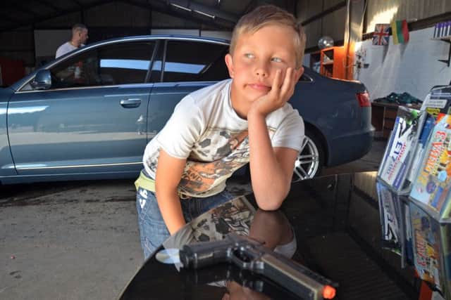 Eduardo (9) is waiting to have his toy gun returned - he's pictured with a similar gun to the one police seized. SG0109815-103TW