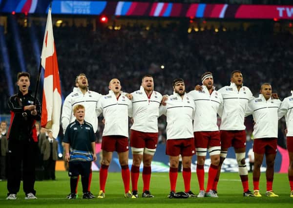 Eight-year-old Henry Sullivan-Porteous stands in front of England Rugby captain Chris Robshaw as the team sing the National Anthem in the opening game of the world cup against Fiji.
Photo: World Rugby/Getty Images EMN-150921-124100001