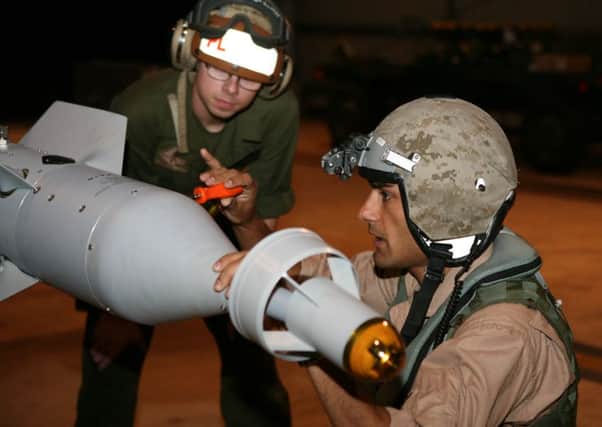 Then Captain Taj Sareen, right, in 2012 when he was also the squadron's quality assurance safety officer, conducting pre-flight checks to ordnance loaded before flight operations
Picture: USMC/Cpl Vanessa Jimenez ANL-151023-110022001