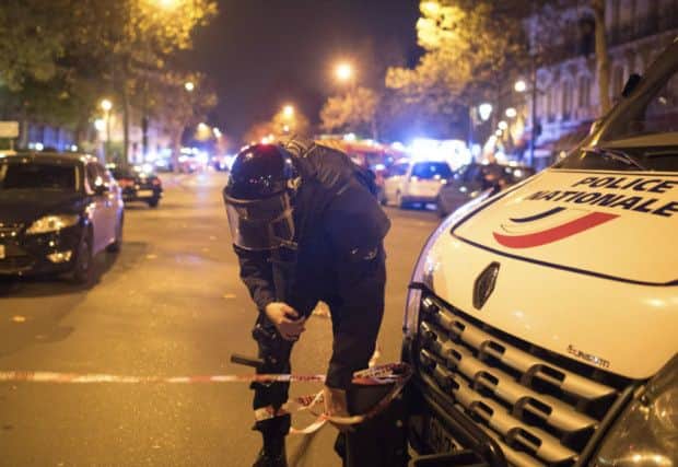 A police officer secures the area outside the Bataclan concert hall in Paris. Picture: AP