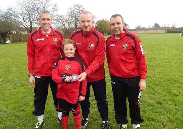 Chloe Wheatley is being handed the paceguard by Mark Jones (Chairman) with Gary Sharman (Coach) and Andrew Wheatley (Dad)