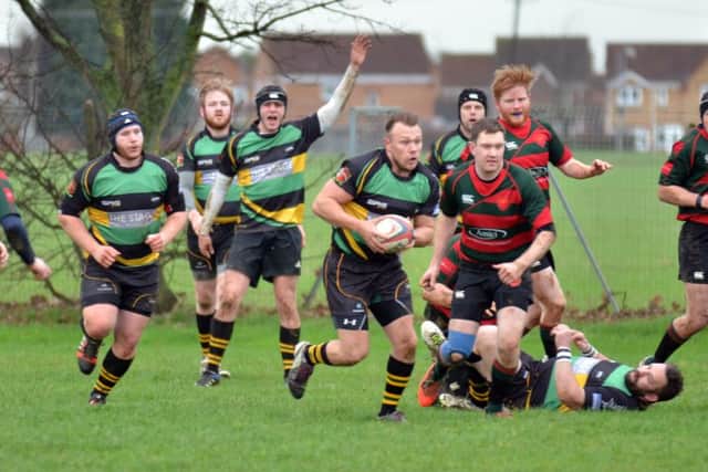 Lance Charity (carrying the ball) who scored two tries for Deepings in their 29-22 win over rivals Thorney.  Photo by Tim Wilson.