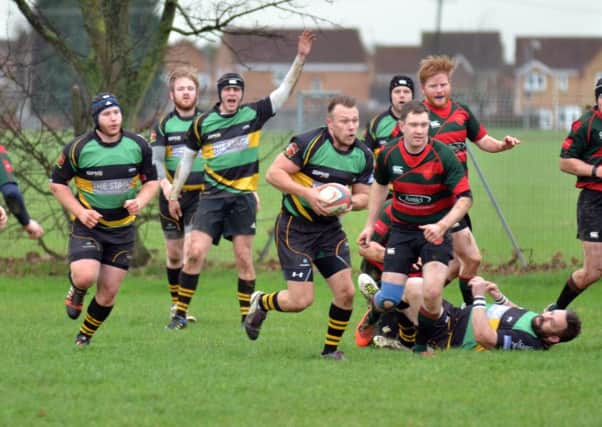 Lance Charity (carrying the ball) who scored two tries for Deepings in their 29-22 win over rivals Thorney.  Photo by Tim Wilson.