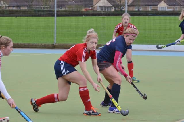 Anna Faux (red) in action for City of Peterborough Ladies against Cambridge City. Photo: David Lowndes.