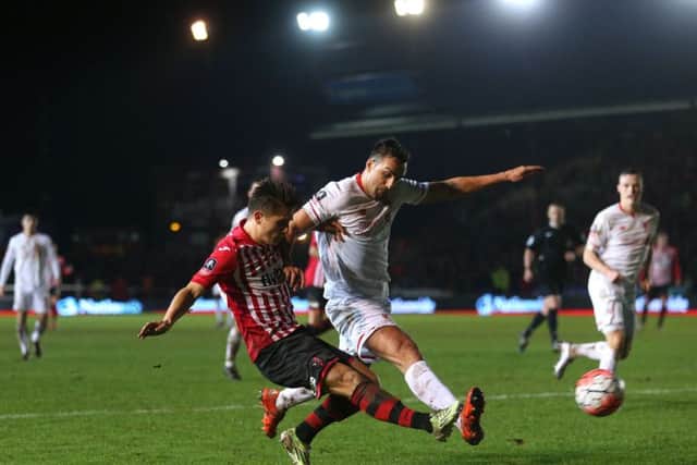 Exeter's Tom Nichols (left) has been linked with a move to Posh. Photo: David Davies/PA Wire.