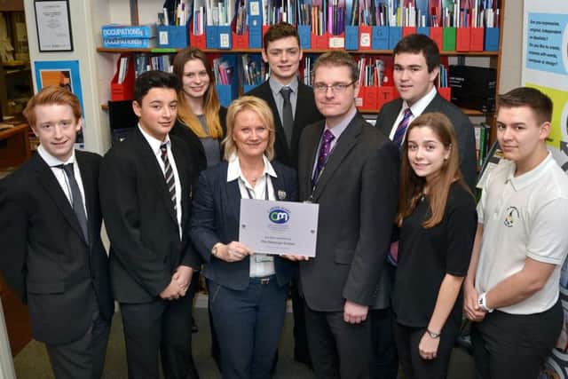 Students at The Deepings School with headteacher Richard Trow (front third right) and careers manager Linda Taylor (third left) with the Career Mark Award. Photo by Tim Wilson.