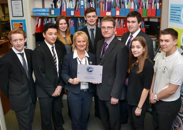 Students at The Deepings School with headteacher Richard Trow (front third right) and careers manager Linda Taylor (third left) with the Career Mark Award.  Photo by Tim Wilson.