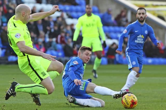 Posh midfielder Harry Beautyman slides into a tackle on Southend defender Adam Barrett. Photo: Joe Dent/theposh.com.