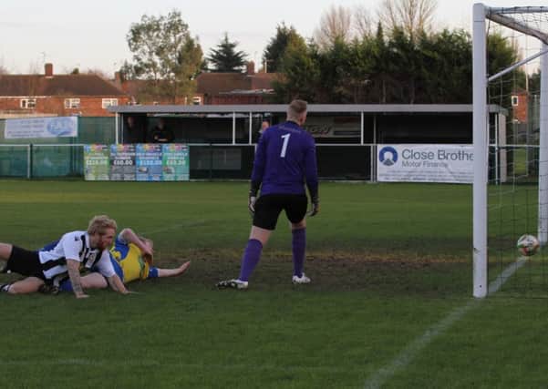 Craig Smith (on fllor, black and white) scores for Peterborough Northern Star against Wellingborough Town. Photo: Tim Gates.