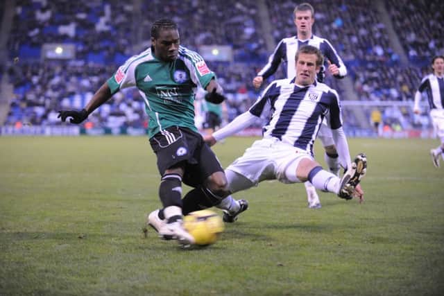 Aaron Mclean (left) in action for Posh at West Brom in the third round of the FA Cup in 2009.