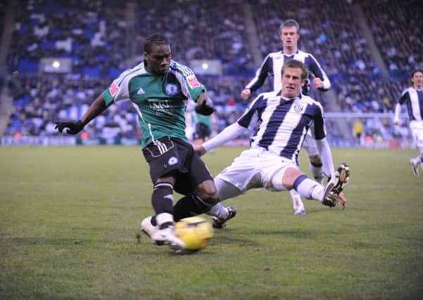 Aaron Mclean (left) in action for Posh at West Brom in the third round of the FA Cup in 2009.