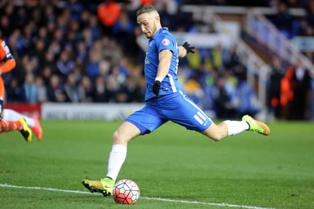 Posh star Marcus Maddison has been watched by Championshop clubs.