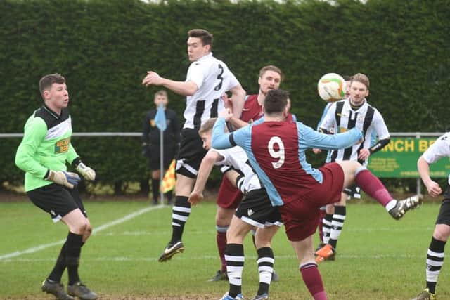 Action from Deeping's 4-2 win over Peterborough Northern Star (stripes). Photo: David Lowndes.