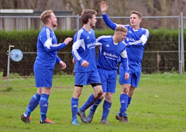 Ollie Maltby (second left) is congratulated after scoring one  of his hat-trick goals against Holbeach United Reserves. Photo: Tim Wilson.
