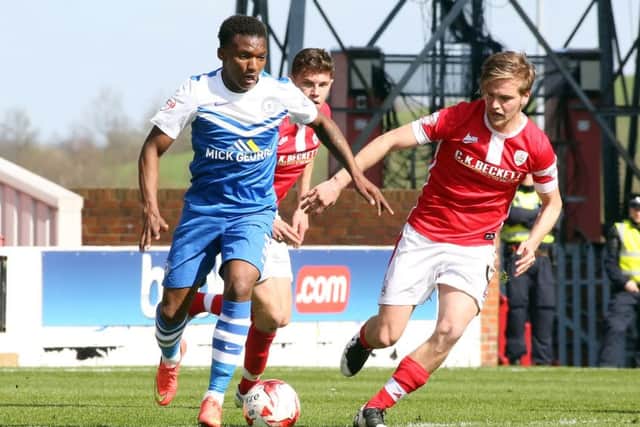 Kgosi Nthle (blue) in action for Posh.