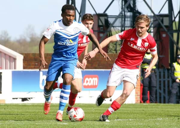 Kgosi Nthle (blue) in action for Posh.