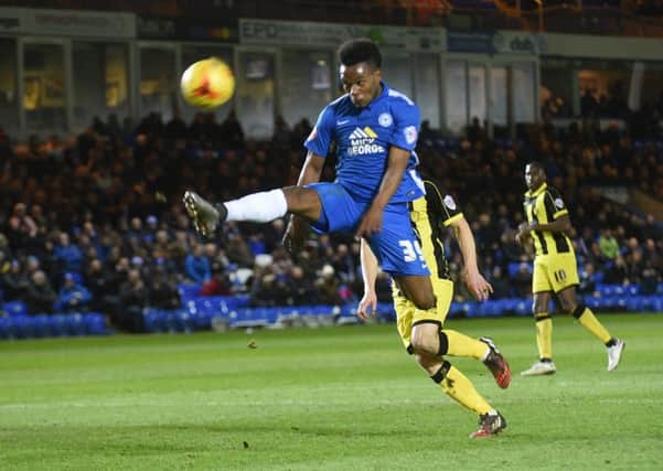 Posh striker Shaquile Coulthirst on the stretch against Burton. Photo: David Lowndes.