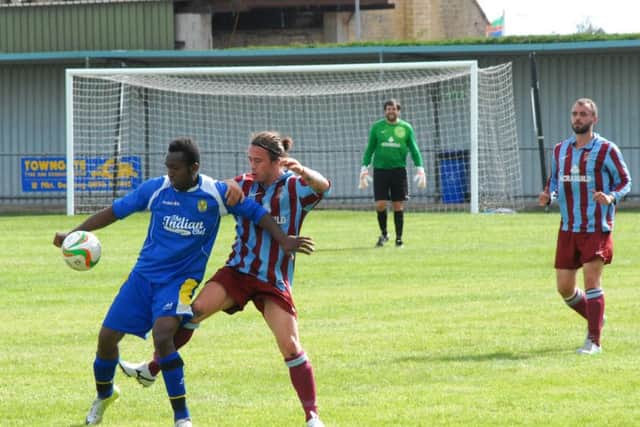 Avelino Vieira (blue) scored for Peterborough Sports against Godmanchester.