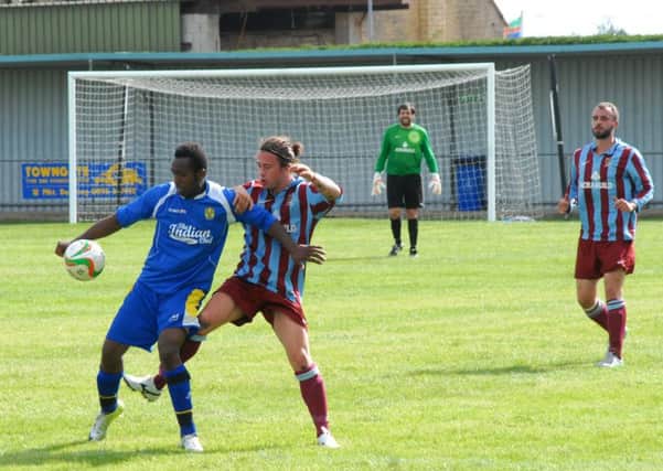 Avelino Vieira (blue) scored for Peterborough Sports against Godmanchester.
