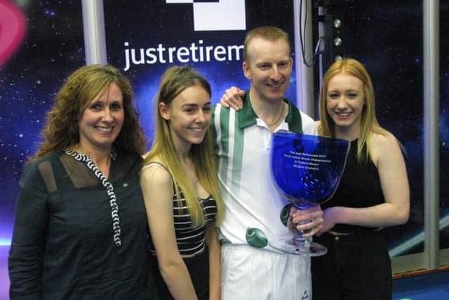 Nicky Brett celebrates his world title win with wife Sam and daughters Lauren and Chloe. Picture: Dominic Picksley