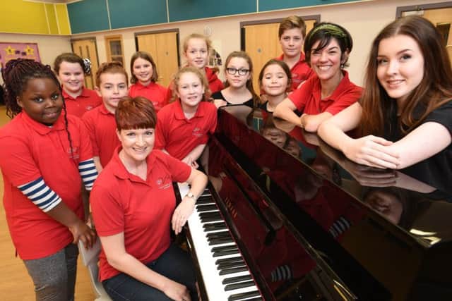 Amanda Villamayor and Jericho Taylor (right) who are to appear in Hairspray at the Cresset with their friends in the Little Voices group and principal Julie Armstrong (sitting). EMN-160302-163526009