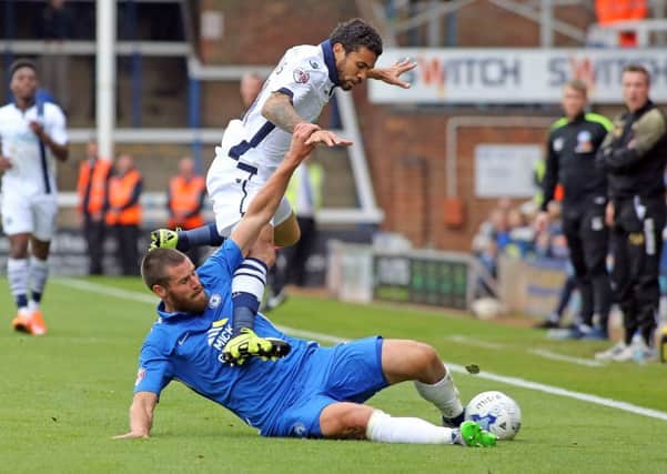 Michael Bostwick (blue) could be back for Posh at West Brom. Photo: Joe Dent/theposh.com.