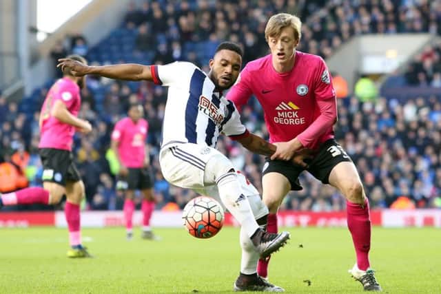 Chris Forrester of Peterborough United gets to grips with Stephane Sessegnon of West Bromwich Albion. Picture: Joe Dent