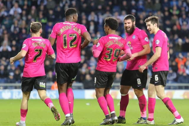 Shaquile Coulthirst (number 39) of Peterborough United celebrates scoring his side's first equalising goal with team-mates. Picture: Joe Dent