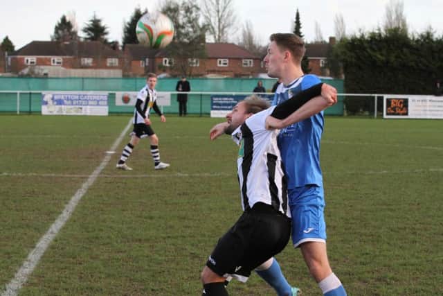 Chris Jones (stripes) battles for possession for Peterborough Northern Star against Desborough. Photo: Tim Gates.