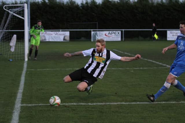 Craig Smith tries to keep the ball in play for Peterborough Northern Star against Desborough. Photo: Tim Gates.