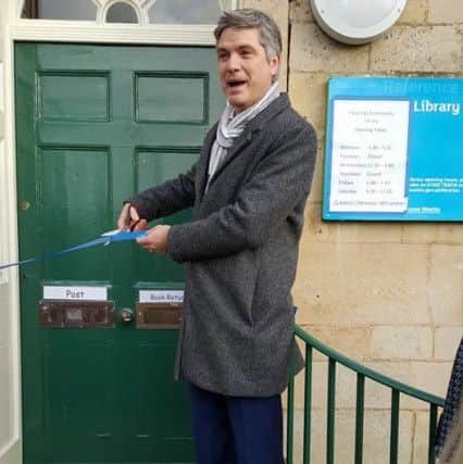 Dr Jonathan Foyle cuts the ribbon at the reopening of Deepings Library. Photo: Friends of Deepings Library. EMN-160102-103319001