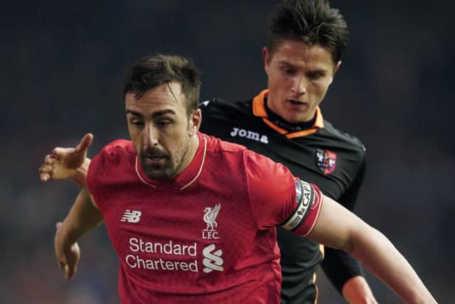 Tom Nichols chellenges Liverpool defender Jose Enrique.