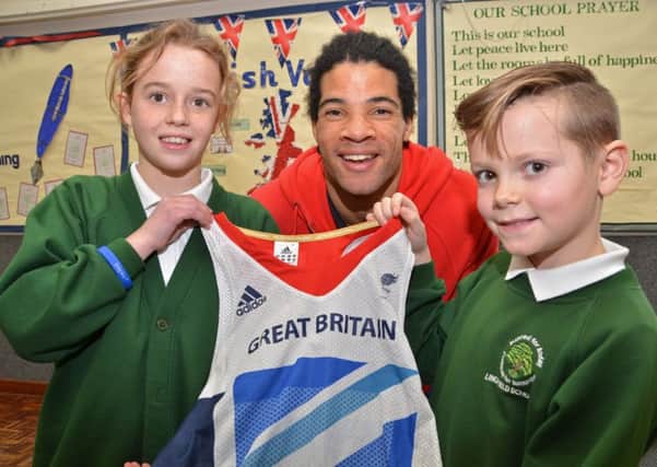 Paralympian athlete Sam Ruddock shows young ambassadors Katie Marsh and Kyle Roberts his London 2012 competition vest at Linchfield Community Primary School, Deeping St James.  Photo by Tim Wilson.